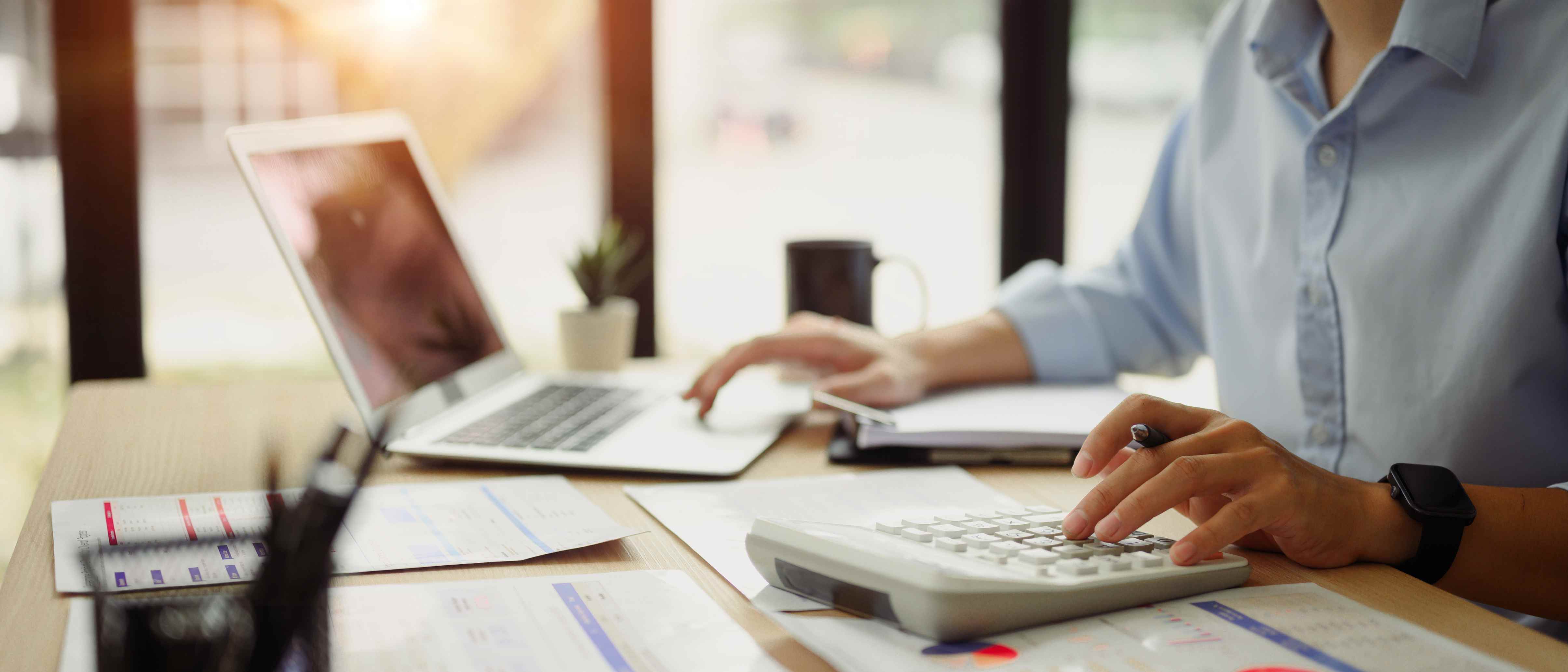 CPA firm accountant working at laptop with calculator