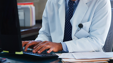 Doctor maintaining healthcare IT security with managed IT services for healthcare. 
