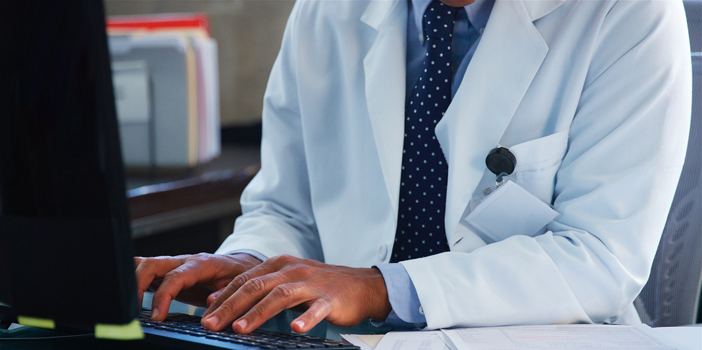 Doctor maintaining healthcare IT security with managed IT services for healthcare. 