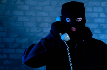 Man in ski mask holding phone